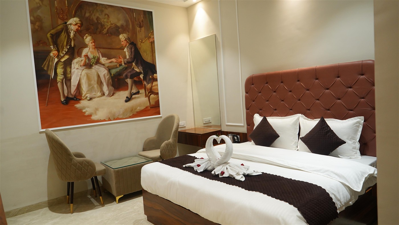 Royal Suite with diamond upholstered headboard and marble floor at THE ROYAL KING Ludhiana